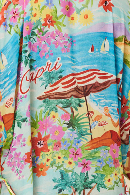 The Capri Maxi Robe in Ocean breathes sun-drenched days spent sipping cocktails and summer romance. Crafted for wanderlust hearts our Robe features hand drawn tropical floral motifs and scattered beach umbrellas by the bluest water