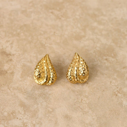 Introducing LUST, our textured tear drop earrings. With their unique design and elegant texture, these earrings are sure to add a touch of luxury and exclusivity to any outfit. 

18Kt Gold Plated Sterling Silver
Crushed Gold Textured Style
Lead,Nickel & Tarnish Free
Hypoallergenic
Measures 2.4cm in length & 2.3cm in width
Weight 19g