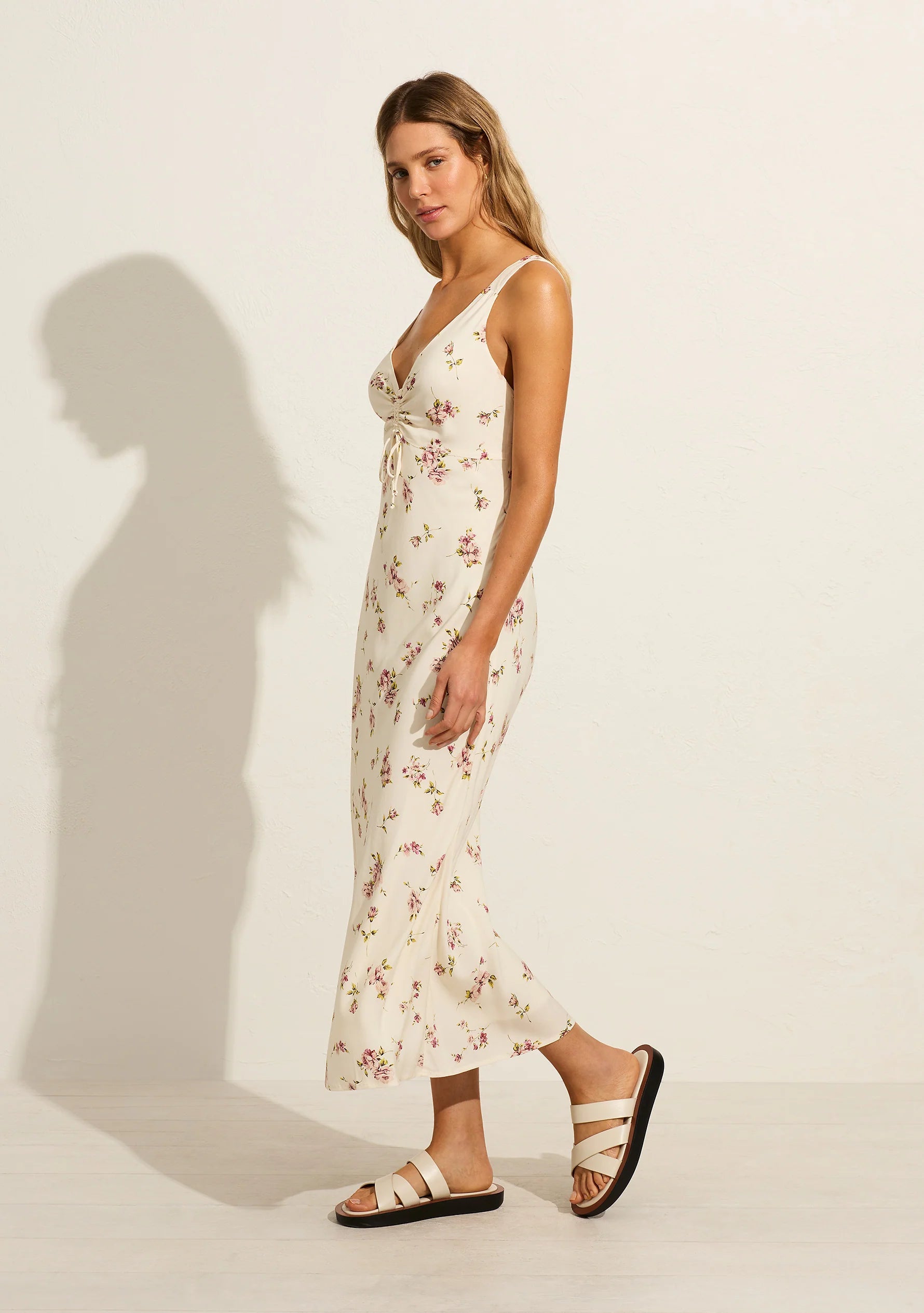 The Melodie Midi Dress in our much loved Isla print features a V neckline with gathered drawstring detail, wide fixed straps, and a flattering bias-cut silhouette that gracefully falls to a draped hem.