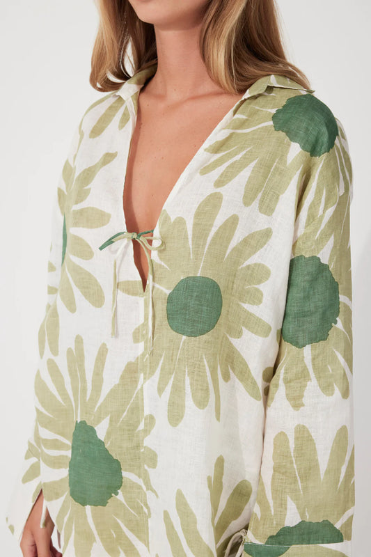 The Aloe Flower Linen Tie Shirt by Zulu & Zephyr is perfect for taking you on and off the sand, featuring an open collar with V-neckline, long sleeve with oversized cuffs, and functional tie detailing at both the cuff and bust, in a lightweight fabrication featuring a custom floral screen print