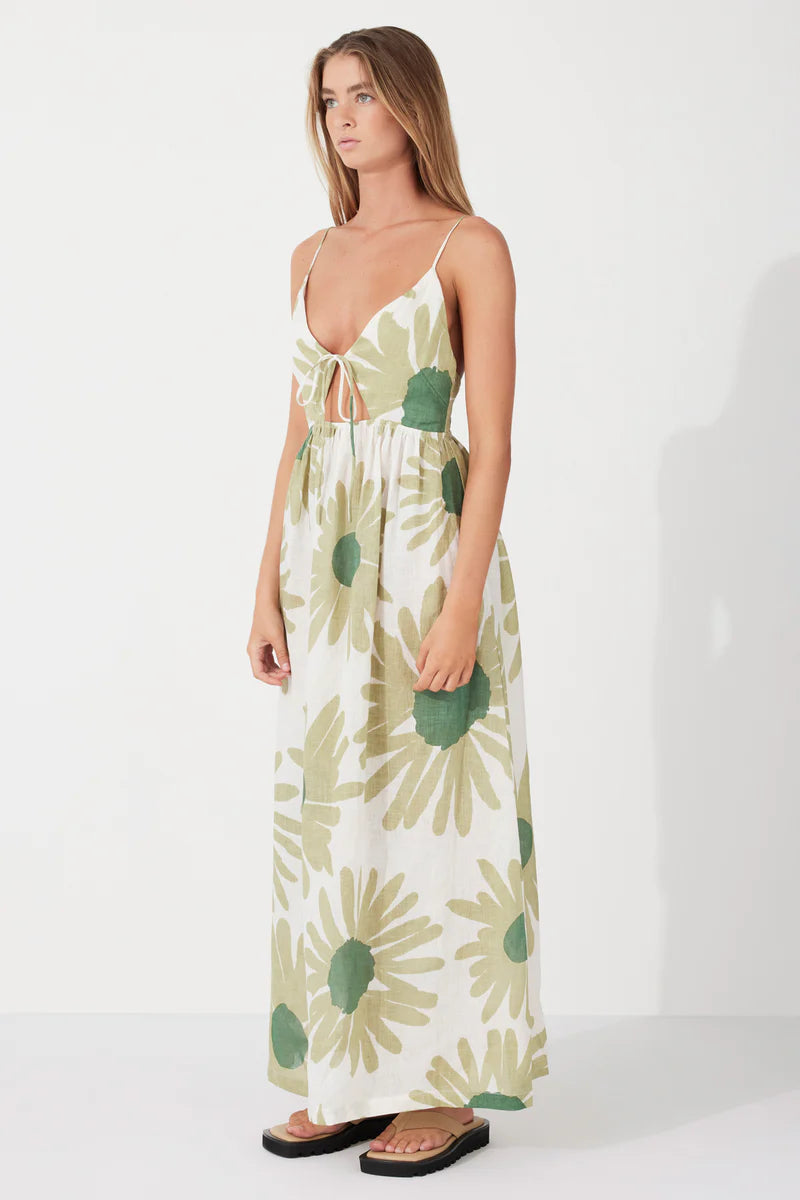 The Aloe Flower Linen Dress by Zulu & Zephyr is a beautiful feminine style featuring a full-length floaty skirt, bust tie detail, and thin shoulder straps which feed through to the back to tie offering an optimum fit, in a lightweight fabrication featuring a custom floral screen print