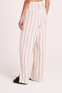 The Aisha Linen Pant is made from our premium linen fabrication in our exclusive Amber Stripe. The silhouette is a relaxed wide leg, full length pant. Features include an elasticated waistband, side seam pockets and slits at hem.