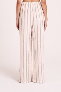 The Aisha Linen Pant is made from our premium linen fabrication in our exclusive Amber Stripe. The silhouette is a relaxed wide leg, full length pant. Features include an elasticated waistband, side seam pockets and slits at hem.