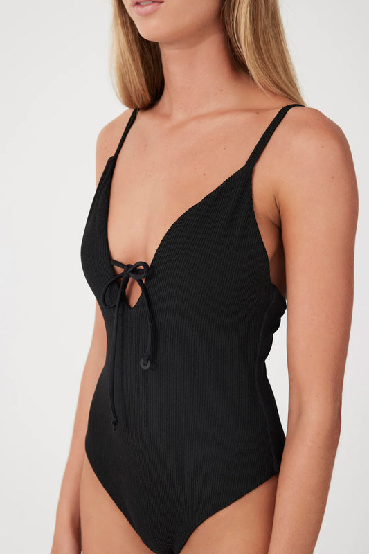 The Black Textured One Piece by Zulu & Zephyr is a minimal shape featuring; a flattering low scoop back, adjustable straps and deep neckline with tie detailing.
