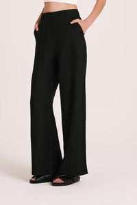 The Amani Tailored Linen pant in black is made from a premium linen which has been washed for a smooth, soft hand feel. The silhouette is a classic tailored fit with a high waist, wide legs and length finishing full length. Features include a functioning fly front, pin stitch on front leg and side seam pockets. 