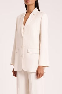 The Koda Blazer is made from a classic suiting fabrication with a smooth hand feel. The silhouette is a structured single breasted shape with classic sloped shoulder, relaxed to slim fit body &amp; full length sleeve. Features include traditional tailoring detailing throughout, tailored vents at sleeves and back of body and Nude Lucy branded buttons.&nbsp;