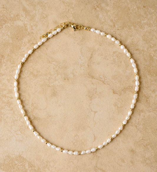 Be the epitome of elegance with LACEY, the fresh water pearl necklace that adds a touch of grace to any outfit. It's the perfect accessory for a classy night out.

S925 Gold Plated Sterling Silver
Freshwater Pearls/Crushed Gold Stones
Lead, Nickel & Tarnish Free
Hypoallergenic
Measures 38cm + 5cm in length