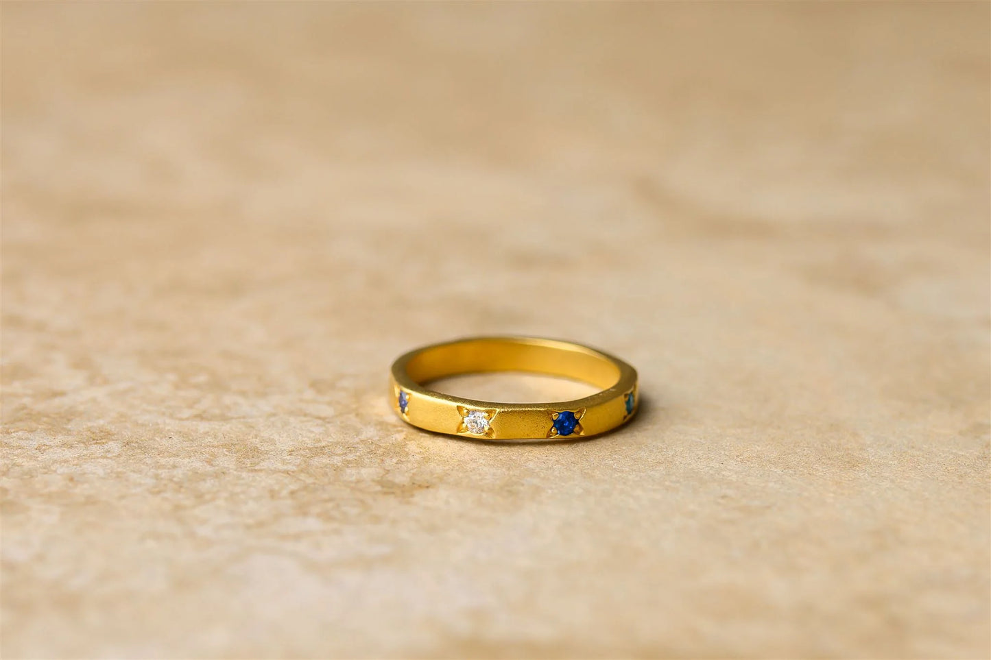 Get ready to make a statement with Ella, the sleek and sassy thin ring adorned with sparkling sapphire stones. Elevate your style with this unique piece that adds a touch of elegance to any outfit. Don't be afraid to show off your playful side with Ella.

925 Gold Plated Sterling Silver&nbsp;
Sapphire Stones
Lead,Nickel &amp; Tarnish Free
Hypoallergenic
Waterproof