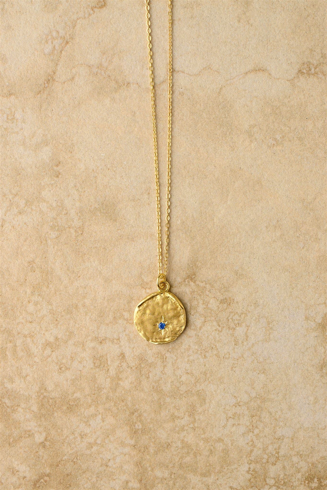 Get starstruck with Sarina! This stunning pendant features a blue sapphire in a unique star shape that will surely steal your heart. Keep it close as a one-of-a-kind keepsake.

925 Gold Plated Sterling Silver&nbsp;
Sapphire Stones
Lead,Nickel &amp; Tarnish Free
Hypoallergenic
Waterproof

Dimensions

Length | 40 + 2.5 + 2.5cm

Pendant Diameter | 16mm