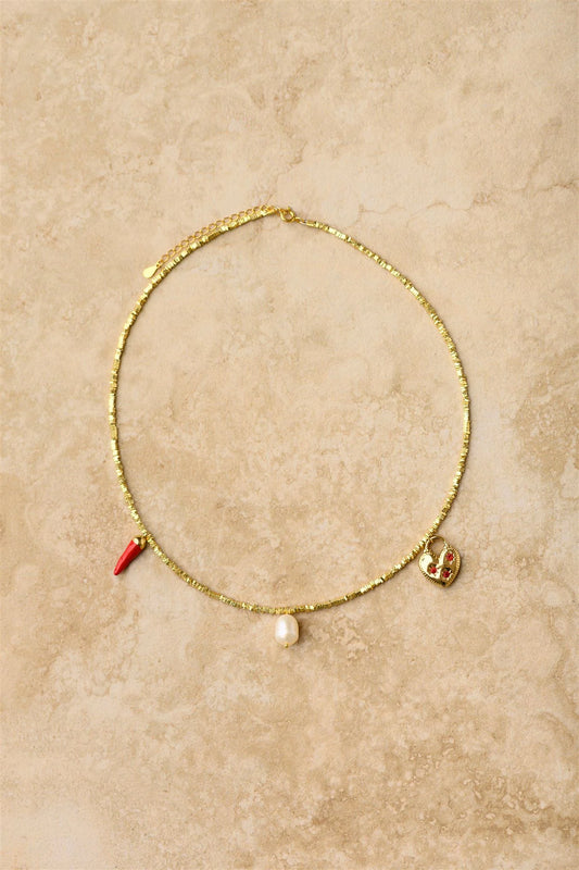 Add a fiery touch to your style with our Chilli Charm Necklace! This eye-catching piece features three vibrant red chilli charms dangling from a stunning crushed gold chain. Perfect for spicing up any outfit, this playful accessory brings just the right amount of heat to your jewellery collection. Makes a sizzling statement whether dressed up or down!

925 Gold Plated Sterling Silver&nbsp;
Lead,Nickel &amp; Tarnish Free
Hypoallergenic
Waterproof