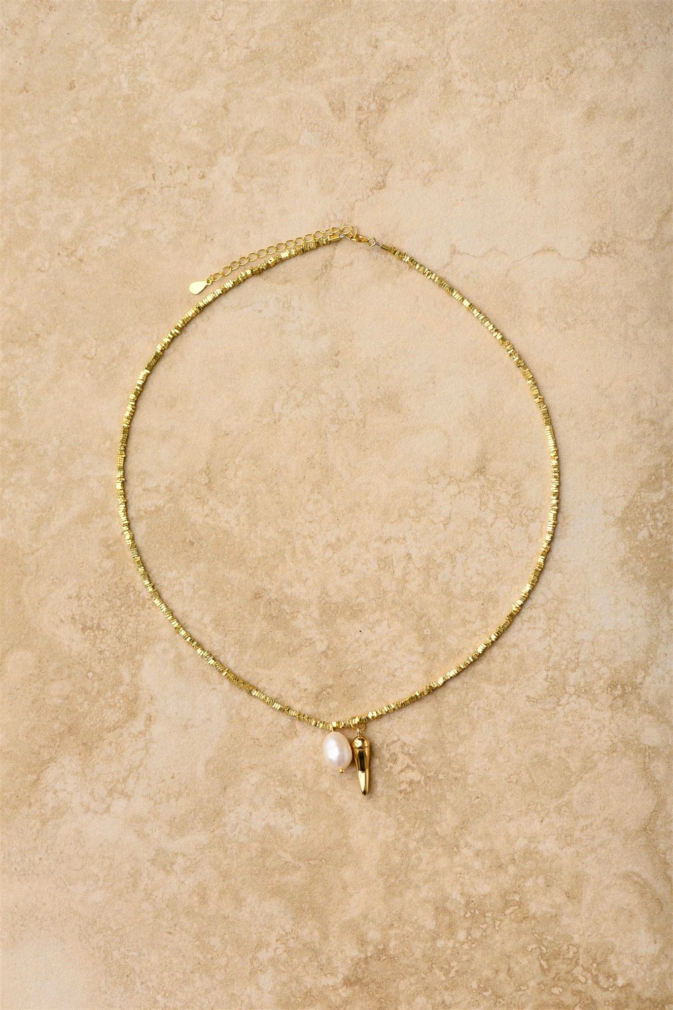For a spicy touch of glam, this 24K gold chilli necklace on a crushed gold fine chain is a must-have. Adorn your neck with this lucky charm, believed to ward off evil and bring good luck. Perfect for adding some playful sass to any outfit. 

24k Gold Plated Sterling Silver 
Lead,Nickel & Tarnish Free
Hypoallergenic
Waterproof