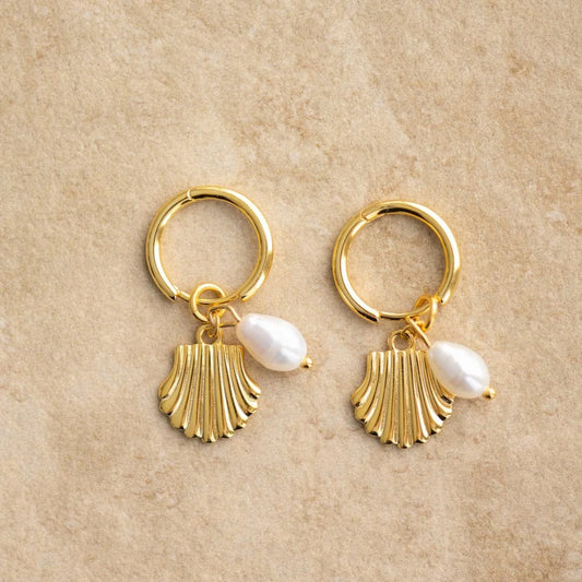 The ISLA earrings will add some seaside charm to any outfit. Grab a pair and shell-abrate your fashion sense!

S925 Gold Plated Sterling Silver
Freshwater pearl/Seashell Charm
Lead,Nickel &amp; Tarnish Free
Hypoallergenic
Measures 3cm in Length