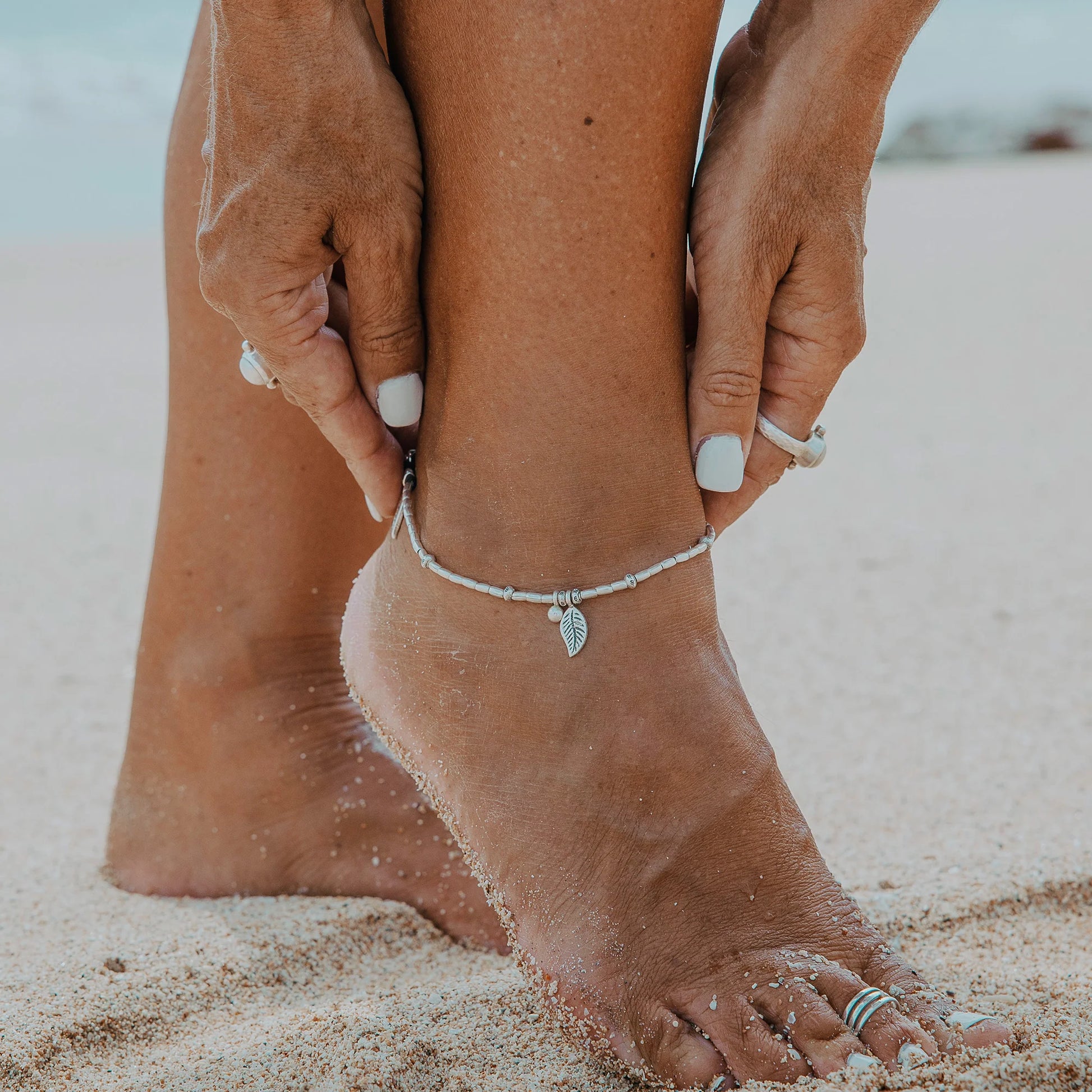 Embark on a dreamy island adventure with our Island Dreaming Anklet. Handcrafted with love, this anklet features Hilltribe Silver beads and charms that exude bohemian charm and coastal elegance. The Poly Wax cotton cord adds a touch of natural texture, while the Sterling Silver clasp and adjustable link ensure a secure and comfortable fit. Let the Island Dreaming Anklet be a reminder of carefree days and the beauty of island living.
