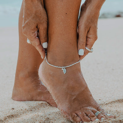 Embark on a dreamy island adventure with our Island Dreaming Anklet. Handcrafted with love, this anklet features Hilltribe Silver beads and charms that exude bohemian charm and coastal elegance. The Poly Wax cotton cord adds a touch of natural texture, while the Sterling Silver clasp and adjustable link ensure a secure and comfortable fit. Let the Island Dreaming Anklet be a reminder of carefree days and the beauty of island living.