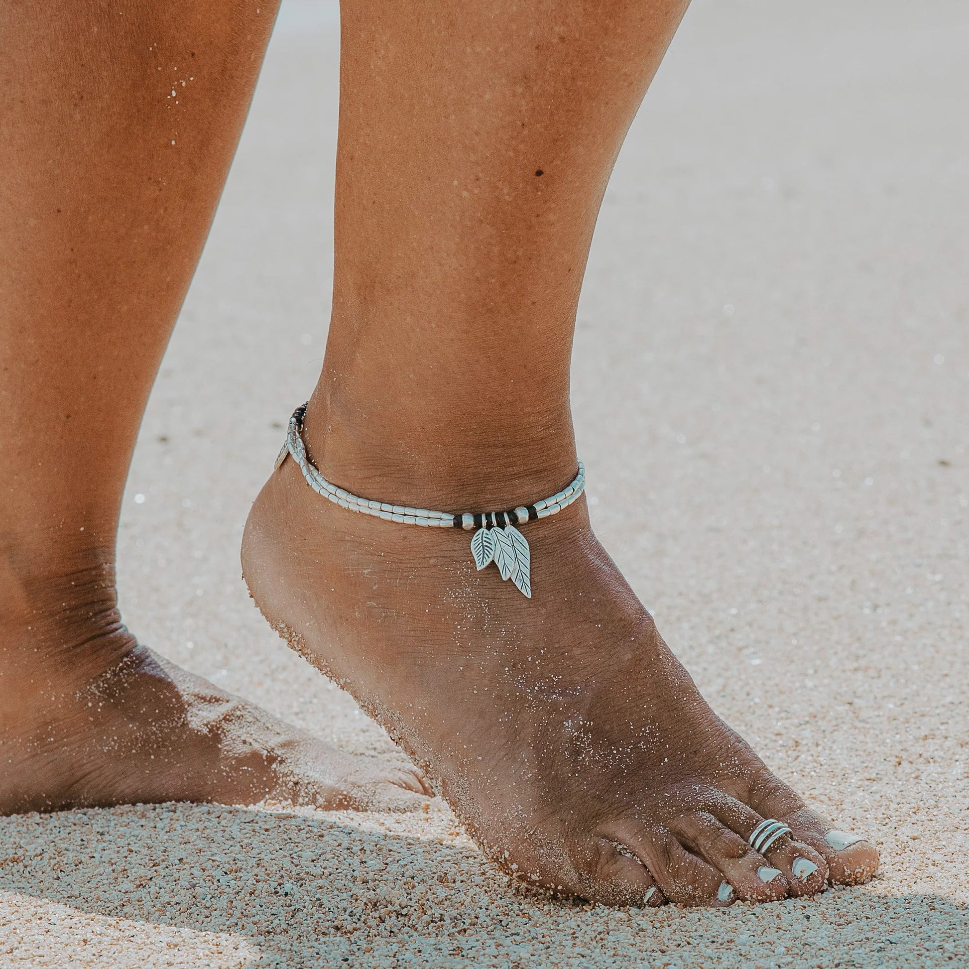 Embark on a soul-stirring journey with the Isola Journey Anklet. Crafted with care, this anklet features handcrafted and stamped Hill Tribe Silver 3 floating Leaf Charms adorned on a soft Polywax Cotton thread. Inspired by wanderlust and the call of the unknown, the Isola Journey Anklet symbolises the spirit of exploration and freedom.
