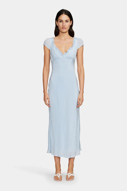 The Lottie Midi Dress is a bias cut slip dress with a low V neckline and a low scooped back. The dress has a ruffle detail around the neckline and cap sleeves. There is a tie at the back of the shoulders to secure the dress and it is fully lined. A gorgeous piece to dress up or down for any occasion.