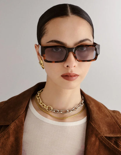 With sharp lines and bold edges the Le Specs Contemplation Super Dark Tort Sunglasses offer a sophisticated and modern unisex look. Designed with a mid-size fit this rectangle frame is finished with a Le Specs flagstripe pin badge.

• Super dark tortoiseshell frame with grey tinted glasses
• Lightweight, durable and impact resistant frame
• Shatterproof and scratch resistant polycarbonate lenses
• Rectangle frame
• Frame material: BPA free polymer plastic (ECOZEN T110 10 Plant Biomass)
• UV protection: Cate
