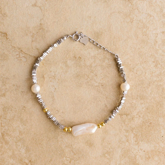 Introducing LUANA, the stunning embellished bracelet. This piece adds a touch of elegance and beauty, making it the perfect piece for your your special day!

S925 Crushed Sterling Silver
Baroque Pearl/Freshwater Pearl/Semi Precious Stones
Lead, Nickel &amp; Tarnish Free
Hypoallergenic
Measures 20cm in length