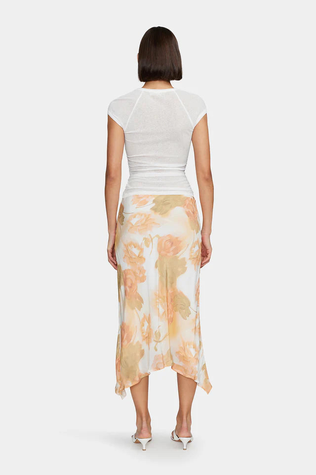 The Martha Baby Tee has a gathered waist for shaping, a crossover hemline detail and capped sheer sleeves. The tee is the perfect elevated staple to pair back with your wardrobe favourites.