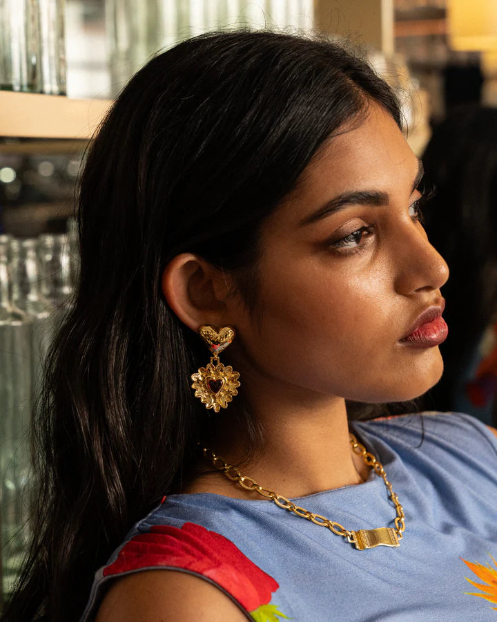 Introducing the divine Cordelia Earrings. Embrace all-consuming love and channel your inner romantic protagonist wearing these beauties. The Cordelia are adorned with a double heart motif reimagined in the most iconic way.