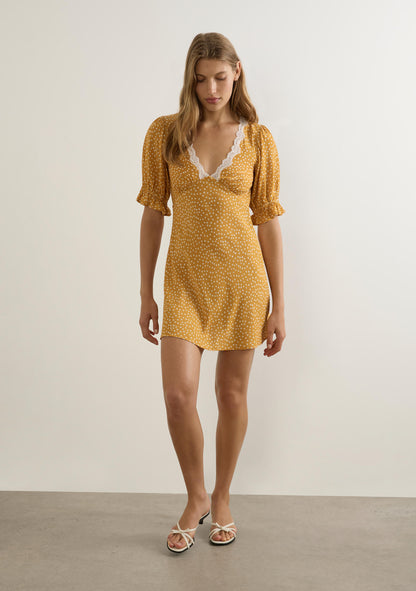 Feminine, flirty, and effortlessly chic — the Myles Mini Dress is your go-to piece for sunshine-filled days and warm evenings out. Designed in a soft mustard hue with a playful white polka-dot print, this mini features a deep V-neckline trimmed with delicate lace, adding the perfect touch of romance.