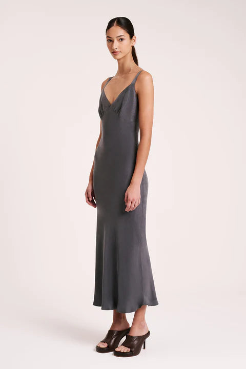The Roni Cupro Slip Dress is made from our signature cupro fabrication with a smooth suede hand feel. Cut on the bias, this silhouette drapes over the body softly and finishes ankle length. Features include a v neckline with a gathered under bust seam, thick adjustable shoulder straps.