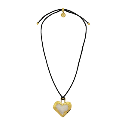 Bold, nostalgic, and steeped in symbolism, the Olympia Necklace reimagines a '90s classic through the lens of Greek antiquity. Featuring a heart-shaped pendant in molten gold and pearlescent enamel, suspended from a sleek black leather cord, Olympia strikes the perfect balance between retro edge and timeless romance.