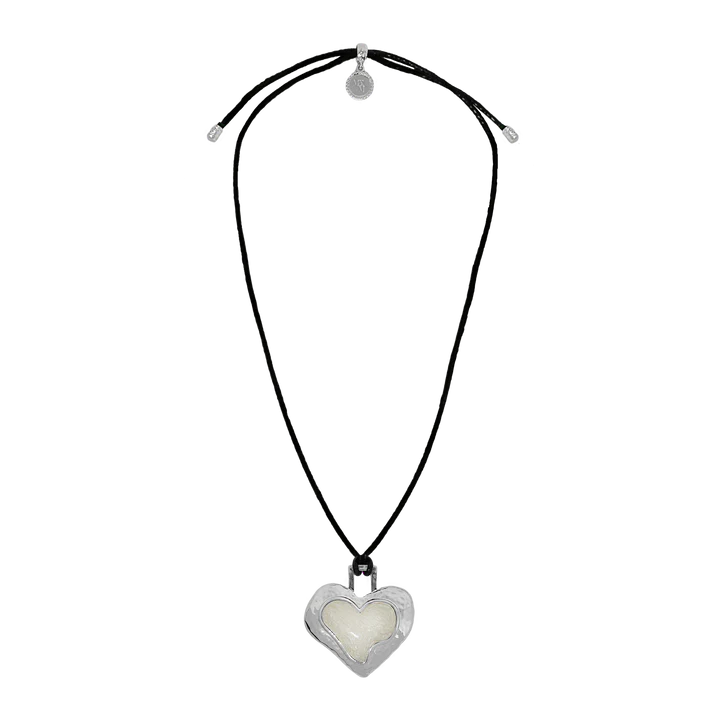 Striking and sentimental, the Olympia Necklace in silver brings together the cool edge of '90s nostalgia with the enduring beauty of Greek mythology. A heart-shaped pendant crafted in molten silver and glowing pearlescent enamel rests effortlessly on a black leather cord—offering a fresh yet timeless take on a beloved classic.