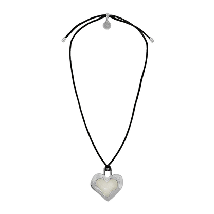 Striking and sentimental, the Olympia Necklace in silver brings together the cool edge of '90s nostalgia with the enduring beauty of Greek mythology. A heart-shaped pendant crafted in molten silver and glowing pearlescent enamel rests effortlessly on a black leather cord—offering a fresh yet timeless take on a beloved classic.