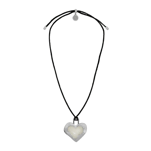 Striking and sentimental, the Olympia Necklace in silver brings together the cool edge of '90s nostalgia with the enduring beauty of Greek mythology. A heart-shaped pendant crafted in molten silver and glowing pearlescent enamel rests effortlessly on a black leather cord—offering a fresh yet timeless take on a beloved classic.