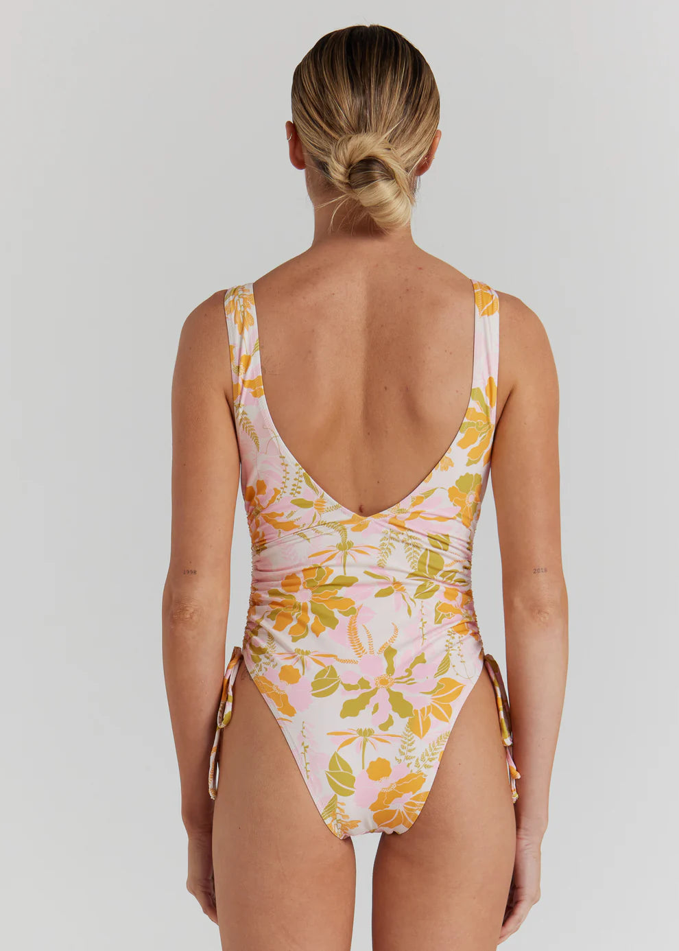 One of our most loved silhouettes in our new vintage inspired floral for the season. Designed with a flattering high cut leg featuring adjustable side ties, the Positano One Piece is a modern interpretation of a classic shape.