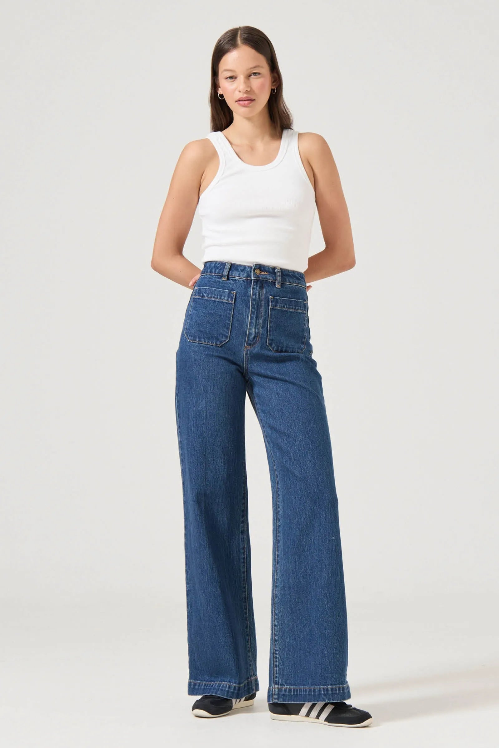 This is a super high-rise, wide leg jean, made with a comfort rigid denim. Fits true to size.


The Sailor Jean Long:
High rise, slim fit with a sailor wide leg
Fits smaller in the waist to eliminate gaps at the back waistband
Features Rolla's signature back pockets &amp; sailor style patch front pockets
Specially angled and shaped in the back for a truly peachy looking butt
Longer leg length, also available in regular
Zip closure
Made with vintage gold toned hardware
