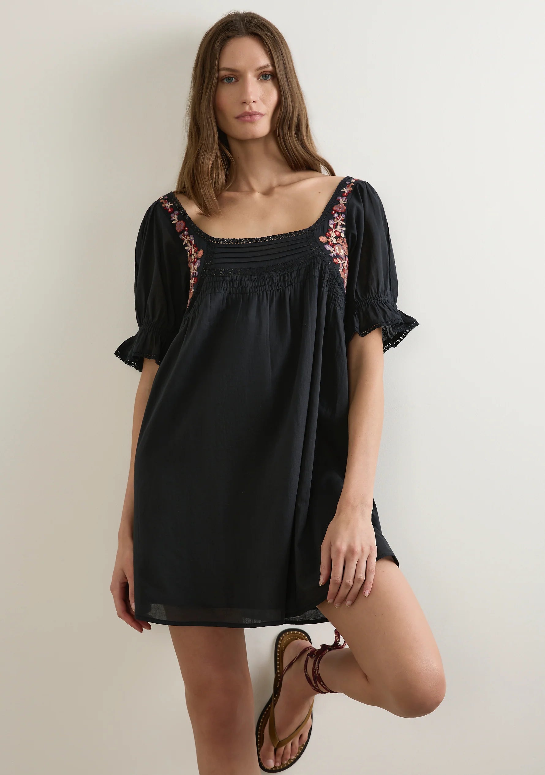 The Lana Mini Dress in black is a sweet bohemian-inspired summer staple, adorned with warm-toned hand embroidery, lace trims, and short puff sleeves with frilled cuffs. With pintucks, soft shirring, and a floaty silhouette, it’s effortlessly feminine for sunshine days and warm nights.

Our studio model Kasia is 182cm / 5'11.5” and wears a Size S.&nbsp;