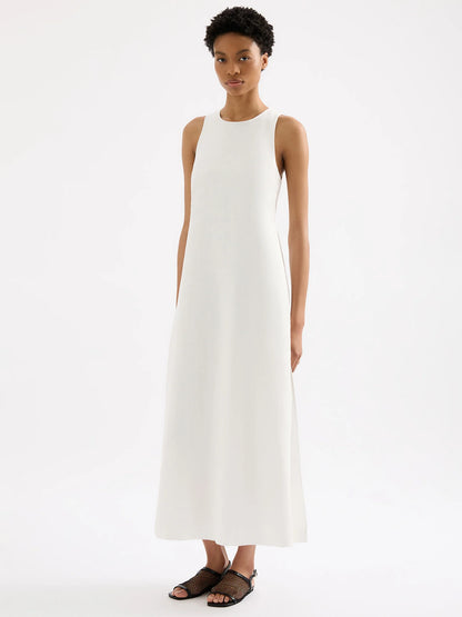 The Thilda Linen Maxi Dress is crafted from 100% linen, pre-washed for a soft, breathable feel. Its feminine silhouette is highlighted by an elastic and tie detail at the back waist, flowing into a full-length skirt. Additional features include a high neckline, a button keyhole opening, and side slits for added movement and style.