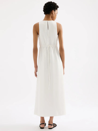 The Thilda Linen Maxi Dress is crafted from 100% linen, pre-washed for a soft, breathable feel. Its feminine silhouette is highlighted by an elastic and tie detail at the back waist, flowing into a full-length skirt. Additional features include a high neckline, a button keyhole opening, and side slits for added movement and style.