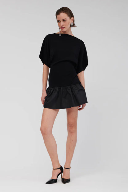 The Naples Drop Waist Mini Dress includes a straight neckline, and in striking classic black exudes a bold yet refined elegance that elevates your ensemble. Its flared skirt simply sits at the hips, making it an ideal choice for both daytime and evening events. The dress is further enhanced by loose sleeves that fall above the elbow, contributing to a relaxed and sophisticated figure.