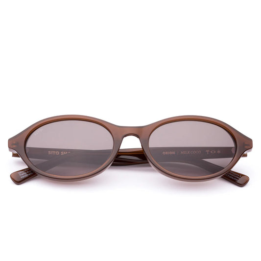 Cool, calm and confident in the most understated way, Orion in Black is the frame that goes with everything and outlasts every trend. Its softly rounded oval shape offers a universally flattering fit, giving effortless balance to any look — whether it’s jeans and a tee or your go-to summer dress. Handcrafted from plant-based acetate in a deep black and fitted with premium coffee tinted UV-protective lenses, Orion is equal parts timeless and sustainable. Designed in Australia for the woman who moves easily b