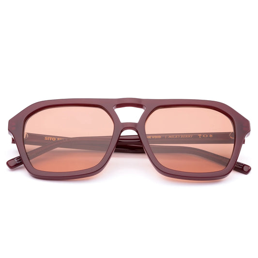 Step up your style with The Void Milky Berry. These unisex aviator sunglasses feature a bold nose bridge and clean, rounded frames in a rich berry tone, offering a modern take on 70s-inspired design. Handcrafted from eco-friendly acetate and fitted with premium lenses, The Void delivers comfort, clarity, and effortless cool.