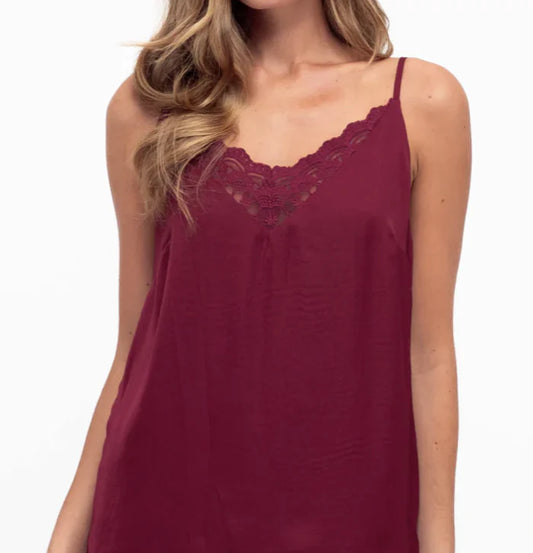 Unleash your bold side with our fierce Liberty Lace Trim Cami in Wine! This stunning top features a silky soft fabric, delicate lace trim, and adjustable straps. It's fully lined for ultimate comfort and style. Lace up your look today!
