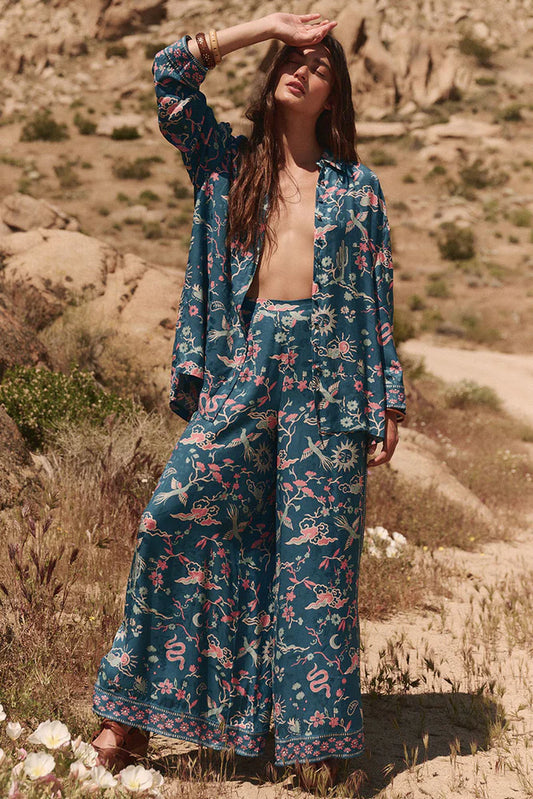 Elevate your wardrobe with the Desert Bandita Wide Leg Pant in Cobalt. Crafted with luxurious silk-like Jacquard woven fabric, these pants feature playful desert motifs in eye-catching hues. The statement wide-leg silhouette provides an effortlessly elegant drape, perfect for both daytime adventures and evening soirees. Pair with the matching Desert Bandita Shirt and chunky sandals for a chic off duty look that exudes confidence and sophistication.