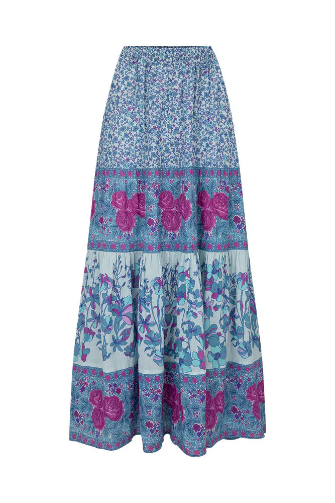 Flowy and free-spirited, the Love Jetty Maxi Skirt in Blue Nirvana is designed for both comfort and style. The elastic waistband allows for different styling options ~ whether worn at the waist or on the hip. Striking bold floral border details artfully placed at each tier and ditsy daisies in dreamy cornflower blue hues and deep magenta transports the wearer to a sunlit meadow in full bloom. Pair with a simple cami and tan mules for an outdoor soirée, or throw on your favourite Spell tee, boots and a chunk