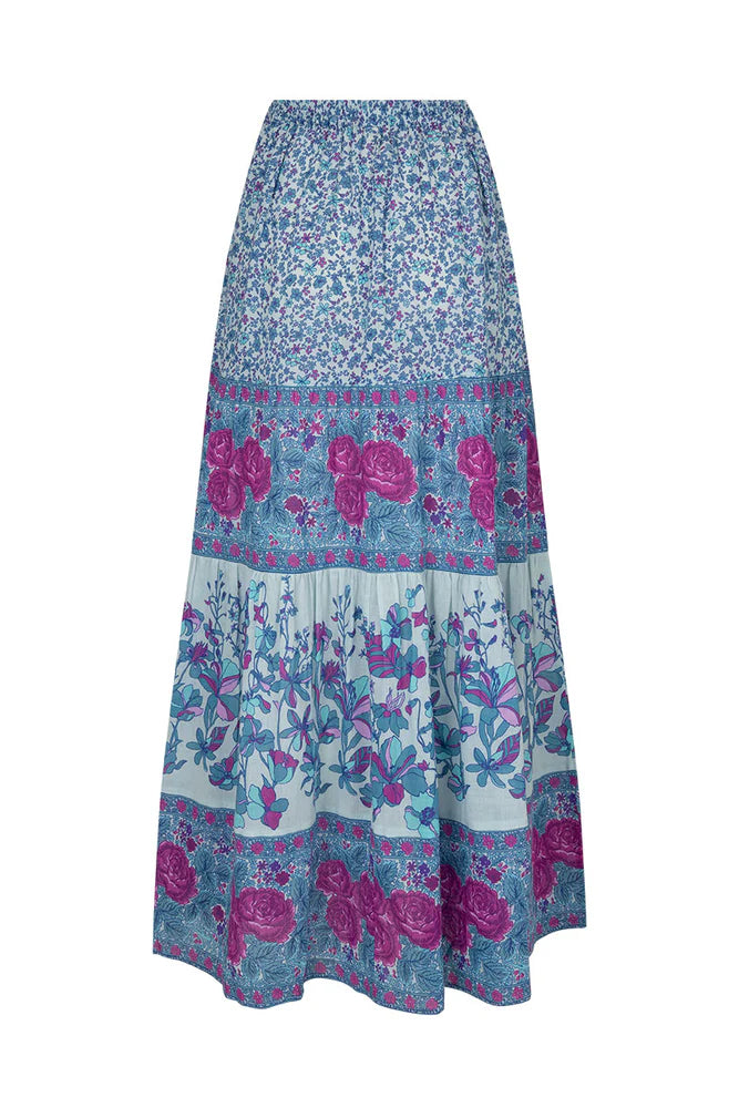 Flowy and free-spirited, the Love Jetty Maxi Skirt in Blue Nirvana is designed for both comfort and style. The elastic waistband allows for different styling options ~ whether worn at the waist or on the hip. Striking bold floral border details artfully placed at each tier and ditsy daisies in dreamy cornflower blue hues and deep magenta transports the wearer to a sunlit meadow in full bloom. Pair with a simple cami and tan mules for an outdoor soirée, or throw on your favourite Spell tee, boots and a chunk