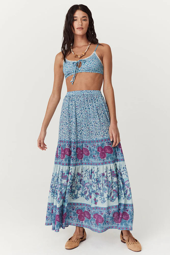 Flowy and free-spirited, the Love Jetty Maxi Skirt in Blue Nirvana is designed for both comfort and style. The elastic waistband allows for different styling options ~ whether worn at the waist or on the hip. Striking bold floral border details artfully placed at each tier and ditsy daisies in dreamy cornflower blue hues and deep magenta transports the wearer to a sunlit meadow in full bloom. Pair with a simple cami and tan mules for an outdoor soirée, or throw on your favourite Spell tee, boots and a chunk