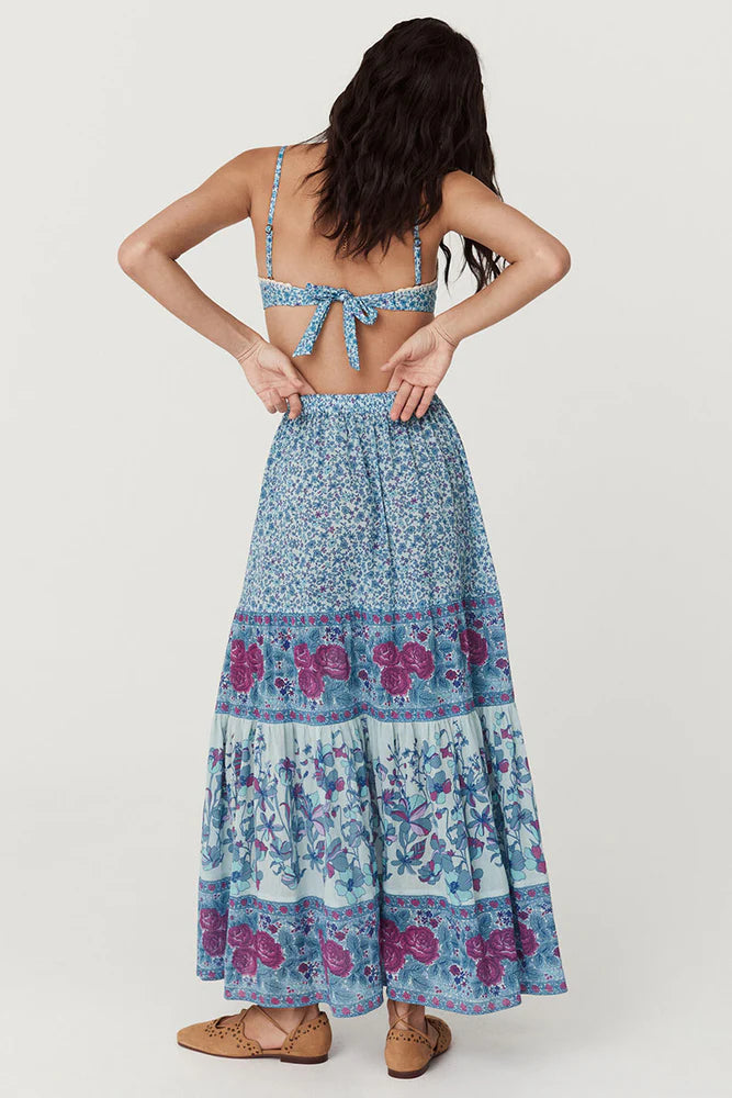 Flowy and free-spirited, the Love Jetty Maxi Skirt in Blue Nirvana is designed for both comfort and style. The elastic waistband allows for different styling options ~ whether worn at the waist or on the hip. Striking bold floral border details artfully placed at each tier and ditsy daisies in dreamy cornflower blue hues and deep magenta transports the wearer to a sunlit meadow in full bloom. Pair with a simple cami and tan mules for an outdoor soirée, or throw on your favourite Spell tee, boots and a chunk