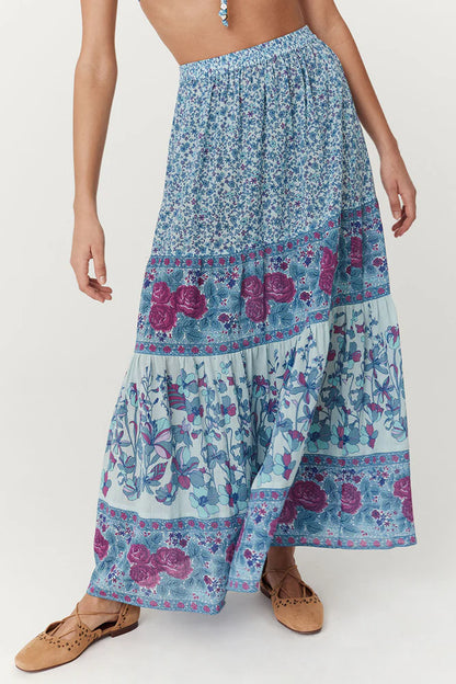 Flowy and free-spirited, the Love Jetty Maxi Skirt in Blue Nirvana is designed for both comfort and style. The elastic waistband allows for different styling options ~ whether worn at the waist or on the hip. Striking bold floral border details artfully placed at each tier and ditsy daisies in dreamy cornflower blue hues and deep magenta transports the wearer to a sunlit meadow in full bloom. Pair with a simple cami and tan mules for an outdoor soirée, or throw on your favourite Spell tee, boots and a chunk