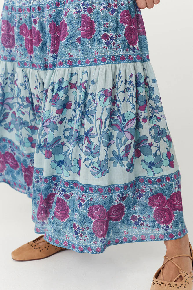 Flowy and free-spirited, the Love Jetty Maxi Skirt in Blue Nirvana is designed for both comfort and style. The elastic waistband allows for different styling options ~ whether worn at the waist or on the hip. Striking bold floral border details artfully placed at each tier and ditsy daisies in dreamy cornflower blue hues and deep magenta transports the wearer to a sunlit meadow in full bloom. Pair with a simple cami and tan mules for an outdoor soirée, or throw on your favourite Spell tee, boots and a chunk