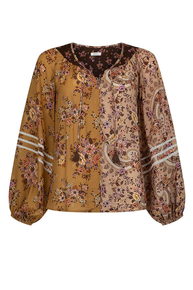 The Melody Blouse in Woodstock is crafted for the rebel hearts. Our newest blouse features a unique patchwork print placement from the design team ~ our honeyed amber print to one side, our rambling florals in pink and cream to the other with our retro brown and ditsy floral print across the back yoke complete this statement style and echo the free spirit of our rebel muse. Inserted ladder lace frames the billowing sleeves, a button down front offers styling versatility while the neck line includes ties wit