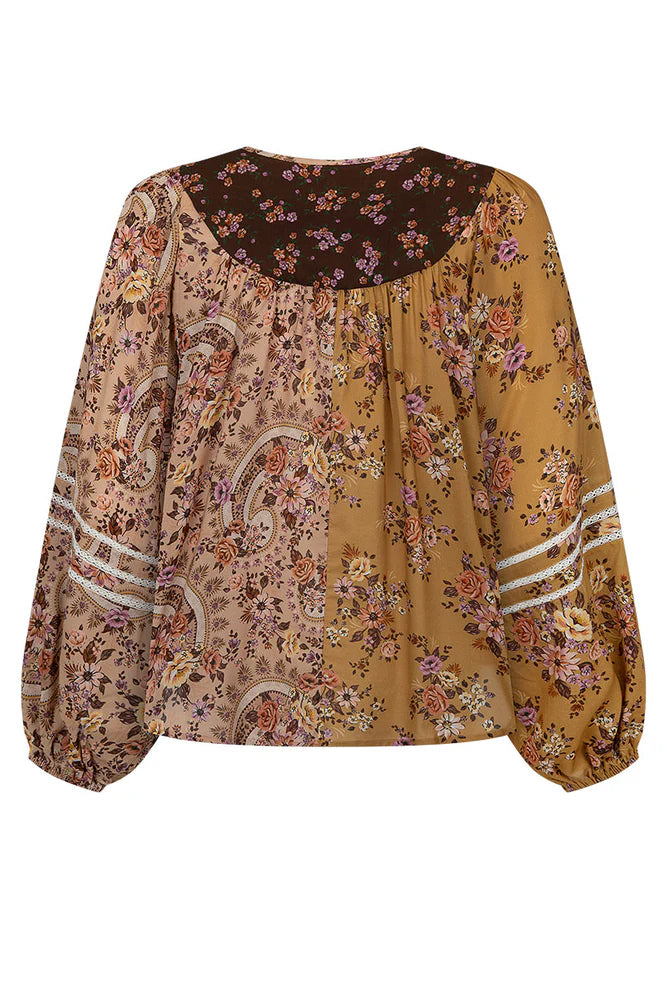 The Melody Blouse in Woodstock is crafted for the rebel hearts. Our newest blouse features a unique patchwork print placement from the design team ~ our honeyed amber print to one side, our rambling florals in pink and cream to the other with our retro brown and ditsy floral print across the back yoke complete this statement style and echo the free spirit of our rebel muse. Inserted ladder lace frames the billowing sleeves, a button down front offers styling versatility while the neck line includes ties wit