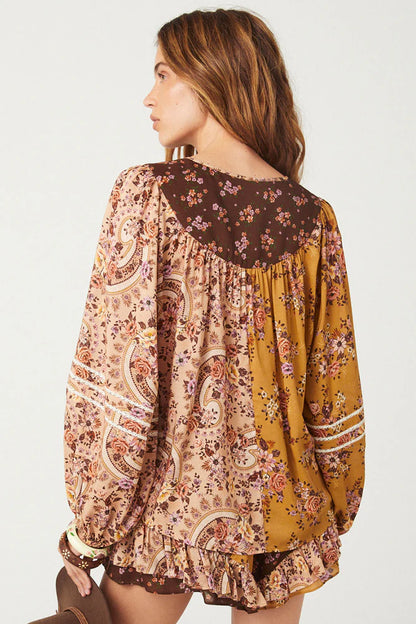 The Melody Blouse in Woodstock is crafted for the rebel hearts. Our newest blouse features a unique patchwork print placement from the design team ~ our honeyed amber print to one side, our rambling florals in pink and cream to the other with our retro brown and ditsy floral print across the back yoke complete this statement style and echo the free spirit of our rebel muse. Inserted ladder lace frames the billowing sleeves, a button down front offers styling versatility while the neck line includes ties wit