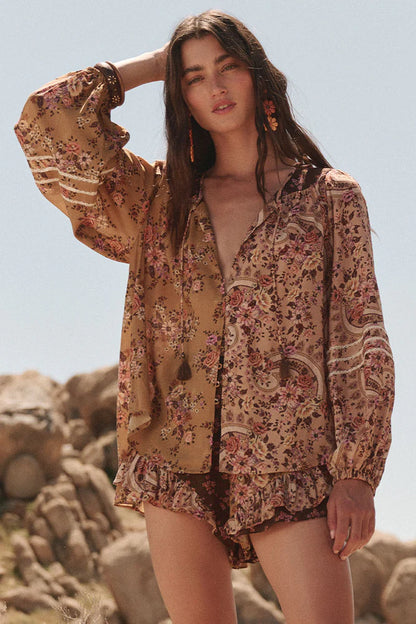 The Melody Blouse in Woodstock is crafted for the rebel hearts. Our newest blouse features a unique patchwork print placement from the design team ~ our honeyed amber print to one side, our rambling florals in pink and cream to the other with our retro brown and ditsy floral print across the back yoke complete this statement style and echo the free spirit of our rebel muse. Inserted ladder lace frames the billowing sleeves, a button down front offers styling versatility while the neck line includes ties wit